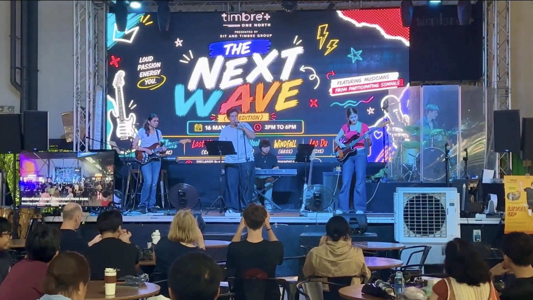 Band performing for the audience at The Next Wave